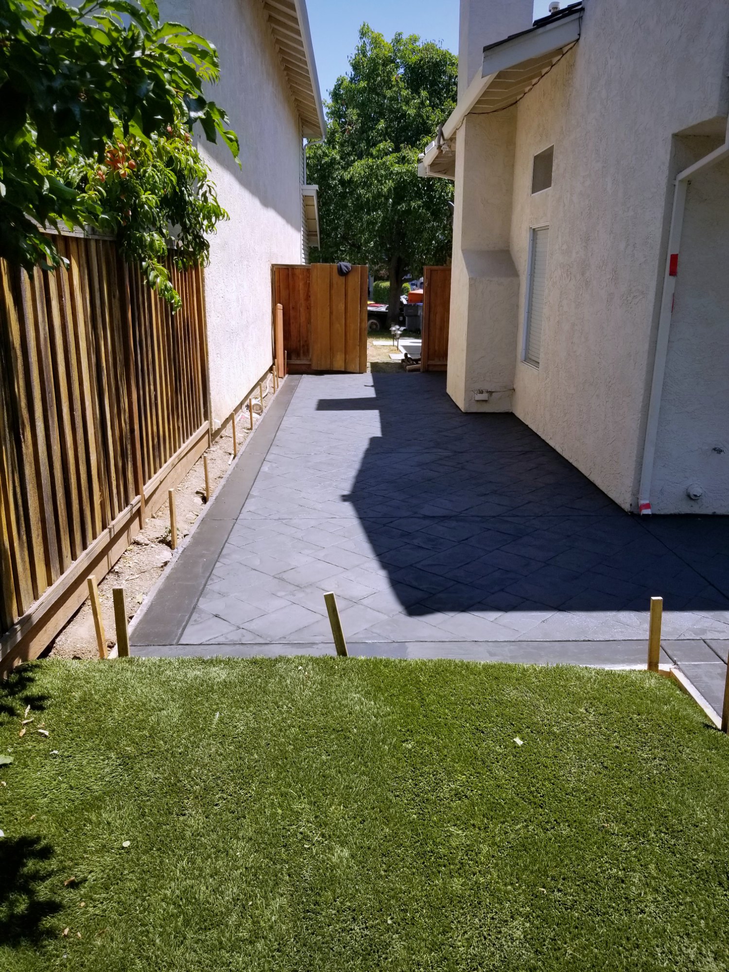 Side-yard stamped concrete walkway with contrasting border