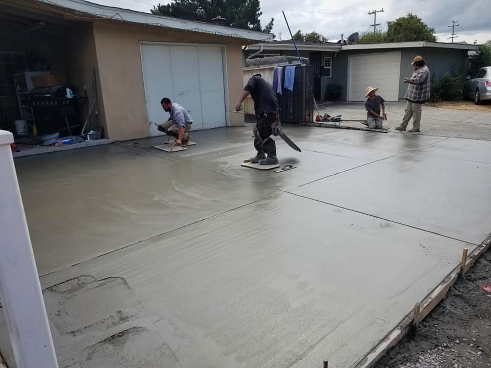Crew power-troweling a fresh concrete slab
